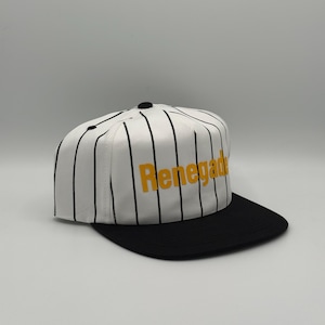 May include: A white baseball cap with black vertical stripes and a black brim. The word "Renegade" is printed in yellow across the front of the cap. The cap has a black button on top.