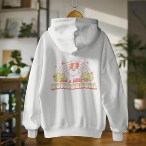 May include: White hoodie with a rainbow and a cartoon face with the text "Just a little bit Homosexual" in pink and green.