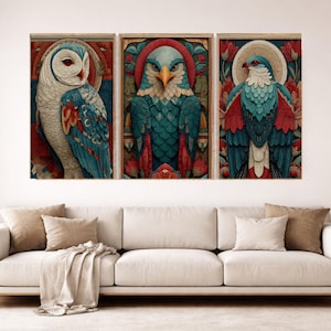 May include: Three framed art prints featuring stylized bird illustrations. The artwork showcases an owl, an eagle, and a bird with teal, red, and white plumage. The prints are displayed above a white sofa, adding a decorative touch to the living space.