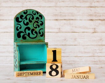 Wooden perpetual calendar in vintage style with day cubes and months in a caddy box