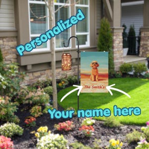 May include: A personalized garden flag featuring a dog wearing sunglasses, with the text "The Smith's". The flag is displayed on a black metal stand in a garden setting. A decorative lantern hangs nearby.