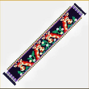 May include: A beaded bracelet with a black background and a repeating pattern of orange and white giraffes with green leaves and purple flowers.