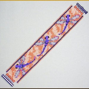 May include: A beaded bracelet featuring a design of three purple dragonflies on a peach background.