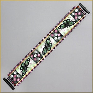 May include: A beaded bracelet with a green, white, and black butterfly design. The bracelet is made with seed beads and has a black clasp.