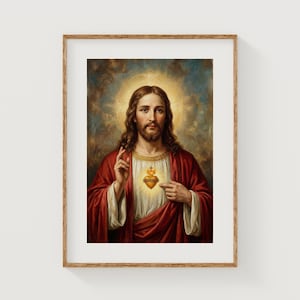 May include: Framed religious artwork depicting a figure with long brown hair and a beard, wearing a red robe and white undergarment. A golden halo surrounds the figure's head. The figure points to a heart with a cross.