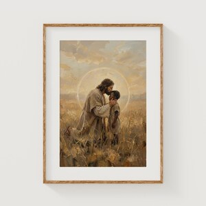May include: A framed print depicts a tender moment. A figure in flowing robes, with a halo, kisses the forehead of a child. The artwork is set in a field of tall grass, with a soft, warm color palette.