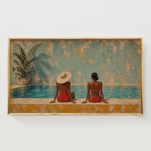 May include: A framed horizontal wall art print depicting two figures sitting on the edge of a swimming pool. One figure wears a straw hat and a red swimsuit, while the other wears a red bikini. A potted palm plant sits beside the turquoise water.