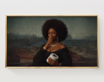 May include: A framed art print featuring a woman in a black dress, gold jewelry, and a large afro, holding a roll of toilet paper. The background is a landscape painting with a gold frame.
