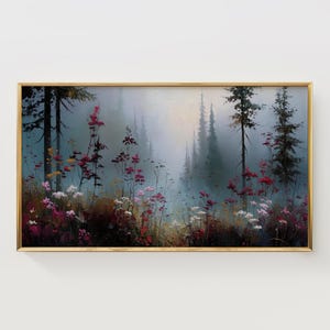 May include: A framed landscape painting depicts a misty forest scene. Tall, dark trees stand in the background, while colorful wildflowers in shades of pink, red, and white bloom in the foreground. The painting has a gold frame.