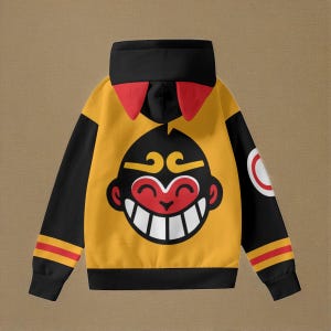 Puede incluir: Sudadera con capucha negra y amarilla con una cara de mono de dibujos animados en la parte delantera. El mono tiene las mejillas rojas y una gran sonrisa.