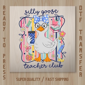 May include: A DTF transfer sheet featuring a cartoon goose wearing glasses and a blue floral bow, holding a blue leopard print tumbler. The design includes school supplies like books, a pencil, scissors, and an apple, with the text silly goose teacher club.