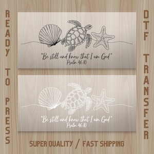 May include: Two DTF transfer designs featuring a seashell, sea turtle, and starfish. The top design is black, and the bottom is white. Both include the text "Be still and know that I am God" Psalm 46:10.