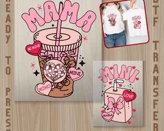 May include: Pink DTF transfer designs featuring a Valentine's Day theme. One design shows a pink iced coffee with the word "MAMA" and heart-shaped candies. Another design shows a pink juice box with the word "MINI".