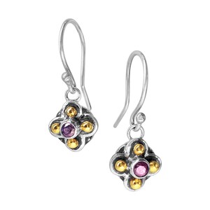 May include: A pair of silver dangle earrings with a small purple gemstone in the center of each earring. The earrings are accented with gold beads.
