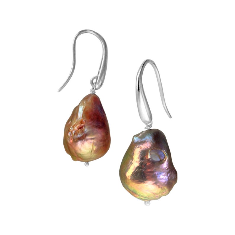 May include: A pair of silver dangle earrings with iridescent brown baroque pearls.
