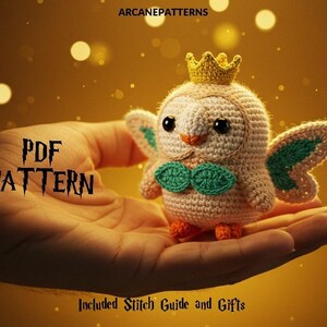 May include: A crocheted owl with a golden crown, teal accents, and orange feet is held in a hand. The text "PDF PATTERN" is displayed in a stylized font. The image has a warm, golden background with bokeh effects.