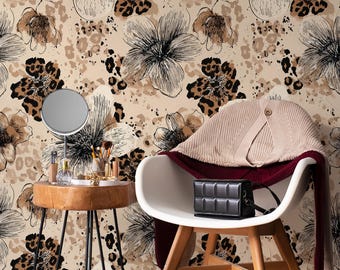 May include: A stylish interior scene featuring a floral wallpaper with black and brown accents. A white chair holds a beige sweater and a black handbag. A small wooden table displays a mirror, makeup, and white heels.