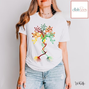 May include: White t-shirt with a colorful tree design. The tree is made up of leaves in shades of green, yellow, orange, and red. The trunk of the tree is a DNA strand. The shirt is a great way to show your love of science and nature.