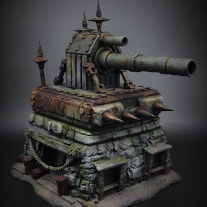 May include: A detailed miniature model of a war tank. The tank features a large cannon, spikes, and a stone-like base. The color palette includes shades of green, brown, and gray, with a weathered appearance. The model is a unique piece of art.