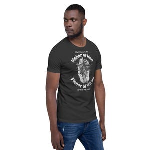 May include: Dark gray t-shirt with a white graphic design featuring the text "Fisher of Men" and "Fisher of Wires." The design includes a stylized image of a fish and electrical wires. The text "Matthew 4:19" and "NFPA 70 NEC" are also printed on the shirt.