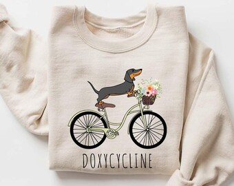 Doxycycline Pun Sweatshirt, Dachshund on Bicycle, Pharmacist Gift