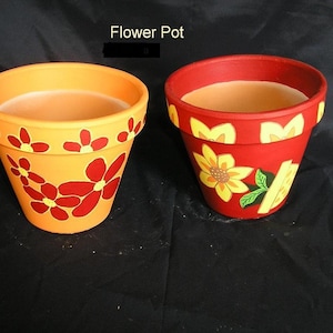 May include: Two terracotta flower pots, one orange with red flowers and one red with yellow sunflowers.  The pots are painted with a simple design.