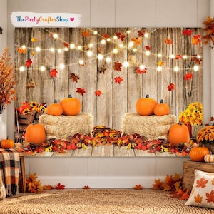 May include: A photography backdrop featuring a rustic wooden wall background with string lights, hay bales, orange pumpkins, and scattered autumn leaves in shades of red, orange, and yellow. The text ThePartyCrafterShop is printed at the top.