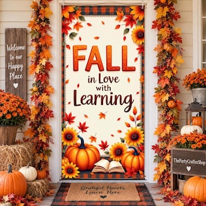 May include: A vertical door banner featuring the text FALL in Love with Learning, decorated with orange pumpkins, sunflowers, and autumn leaves on a cream background. The banner is framed by a plaid border and surrounded by fall-themed decor.