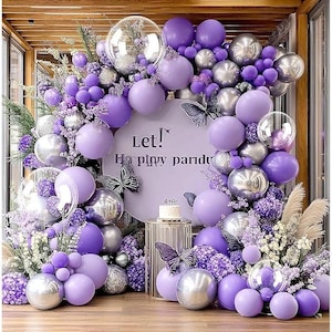 May include: A set of three ceramic mugs with a speckled, matte finish. The mugs are in shades of cream, light gray, and dark gray. Each mug has a simple, minimalist design and a rounded handle. The mugs are stacked on top of each other.