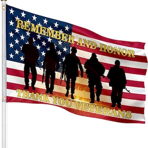 May include: American flag with the text "REMEMBER AND HONOR THANK YOU VETERANS". The flag features silhouettes of soldiers and a gold border. The flag is red, white, and blue.