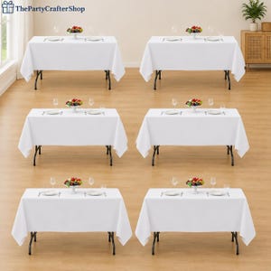May include: Six rectangular folding tables covered with plain white tablecloths, each set with two white plates, two sets of silverware, two clear glasses, and a central bowl of colorful fruit. The logo ThePartyCrafterShop is in the top left corner.