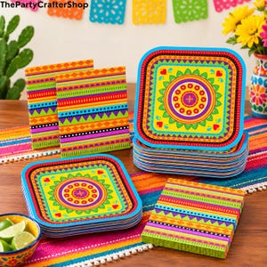 May include: Square paper plates and napkins featuring a vibrant, multi-colored geometric and floral mandala pattern. The plates display a central yellow circle with red flowers, surrounded by green, orange, and blue borders. The napkins have horizontal stripes of various colors and shapes.