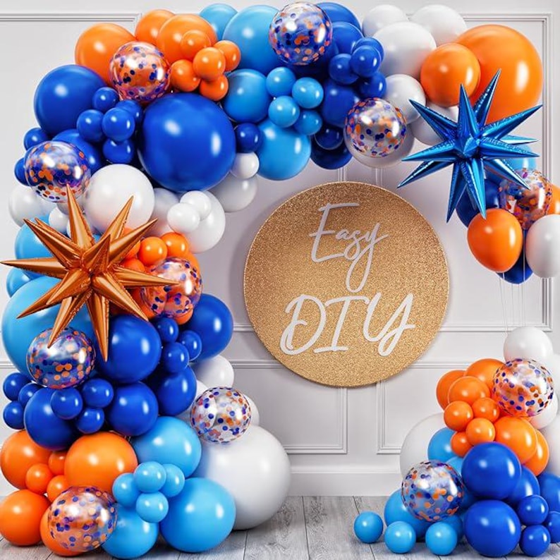 May include: A balloon arch in shades of blue, orange, and white, with star-shaped and confetti-filled balloons. A gold circle with "Easy DIY" text is in the center. Perfect for a party or celebration.