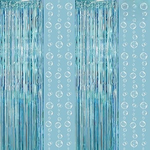 May include: Turquoise blue party backdrop with vertical metallic fringe and strings of clear, round bubble-shaped ornaments. The backdrop is suitable for various celebrations and events.