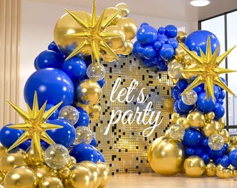 May include: A festive party decoration featuring a backdrop of gold and blue balloons, with gold star-shaped foil balloons. The words "let's party" are displayed in white script on a gold mosaic background. The balloons are arranged in an arch.