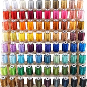 May include: A wooden display rack filled with spools of thread in a wide array of colors. The thread colors include white, silver, gold, red, pink, orange, yellow, green, blue, and brown. The spools are neatly organized on multiple shelves.