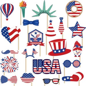 May include: A collection of patriotic photo booth props in red, white, and blue. Includes a hot air balloon, Statue of Liberty, bow tie, star, hat, glasses, and the word "USA". Perfect for Independence Day celebrations.