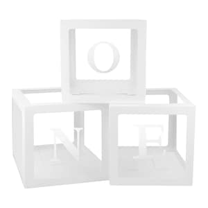 May include: Three white decorative boxes stacked together, each with a letter cutout. The letters spell "ONE". The boxes are square-shaped with open sides, creating a modern and minimalist design.