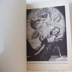 May include: A black and white photo of a woman wearing a black dress with a rose behind her. The caption reads "RINA, DANCING SERAPH OF "I MARRIED AN ANGEL" IN CHANEL'S GUILLELESS BLACK LACE AND CHIFFON"