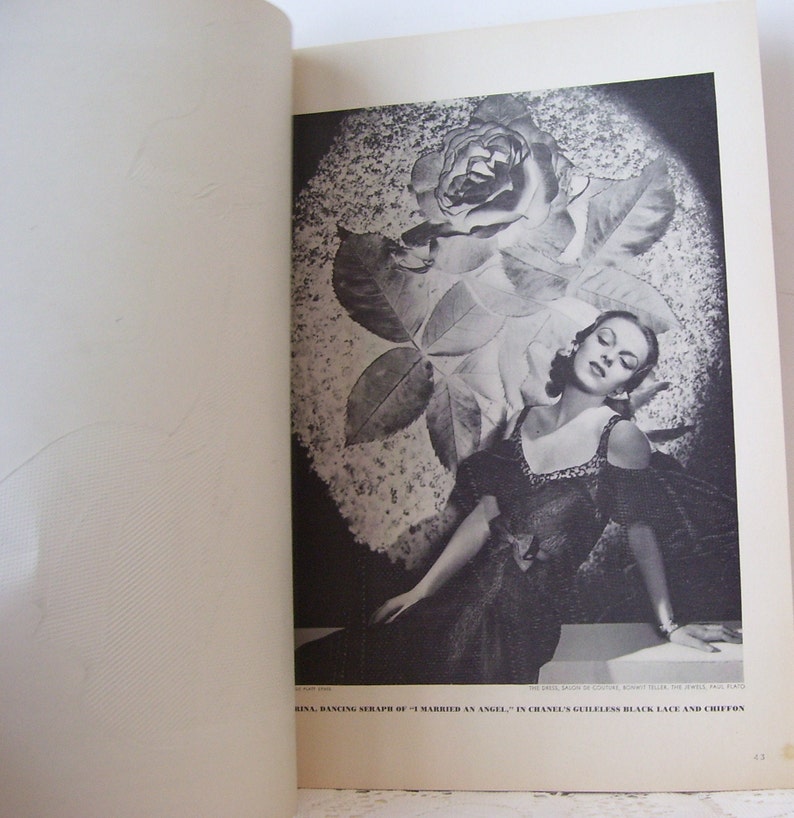 May include: A black and white photo of a woman wearing a black dress with a rose behind her. The caption reads "RINA, DANCING SERAPH OF "I MARRIED AN ANGEL" IN CHANEL'S GUILLELESS BLACK LACE AND CHIFFON"