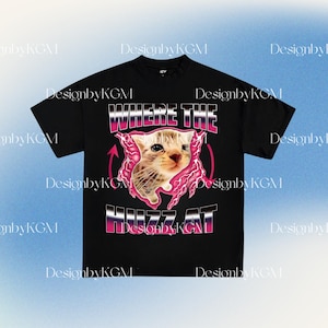 May include: Black t-shirt featuring a graphic of a kitten with the text "WHERE THE HUZZ AT" in a retro font. The design includes pink lightning bolts and arrows, creating a bold, eye-catching look. The shirt is a classic crew neck.