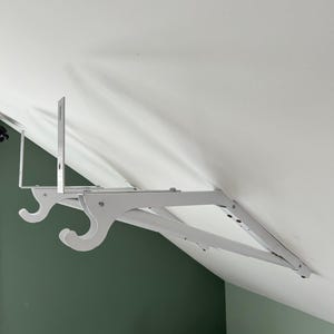 a white swinger on a white ceiling