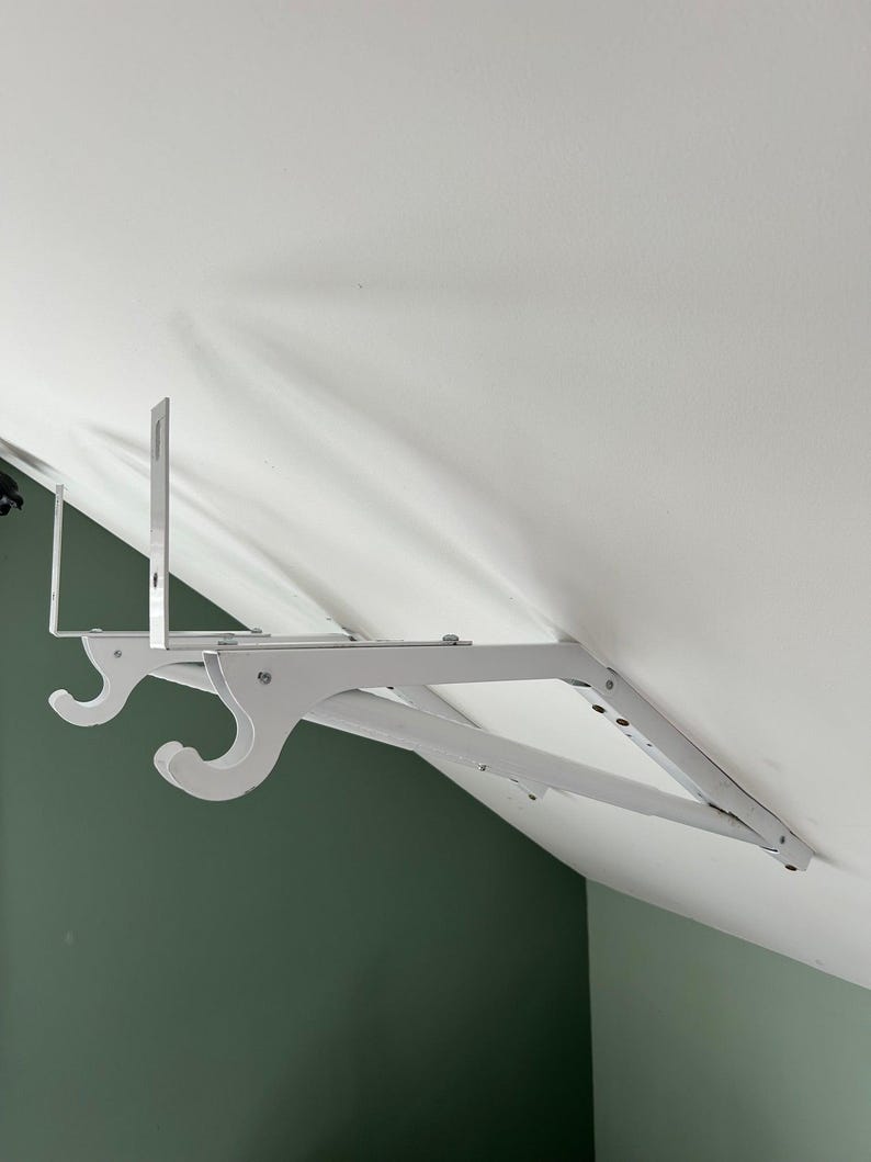 a white swinger on a white ceiling