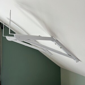 a white bracket on a wall