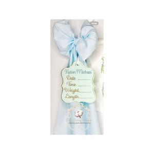 May include: A light blue bow with a decorative tag. The tag is light green with gold trim and has the name "Kipton Michael" and spaces for date, time, weight, and length. The Cotton House logo is at the bottom.