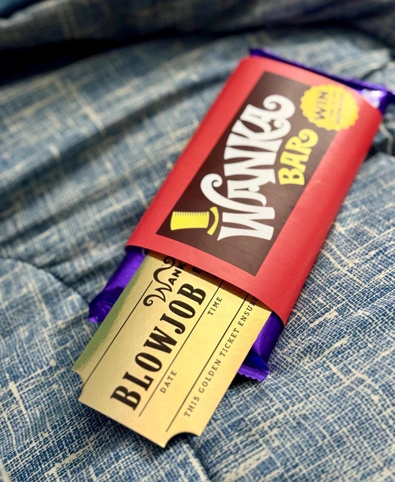 May include: A purple candy bar wrapped in a red paper sleeve with the text Wanka Bar and a yellow top hat icon. A gold-colored ticket is partially pulled out of the sleeve, featuring the text BLOWJOB, DATE, TIME, and THIS GOLDEN TICKET ENSURES.