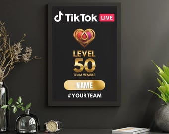 May include: A rectangular black framed wall sign featuring the TikTok Live logo, a gold heart icon, and the text Level 50 Team Member. Below this, a gold horizontal bar displays the word Name, followed by the hashtag #Yourteam in white text.