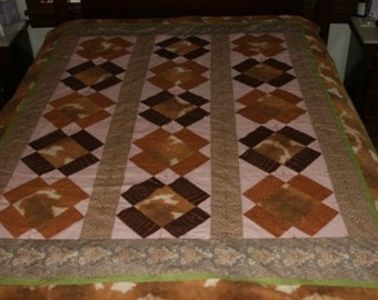 Animal print quilt, 64 x 77. main colors are brown & pink