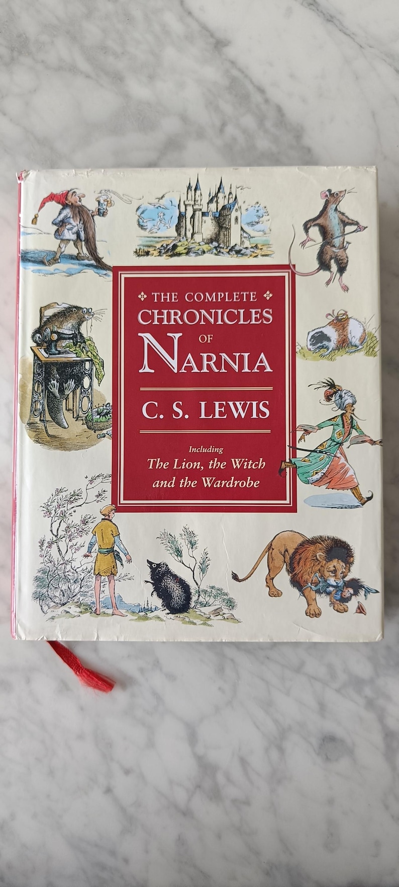 May include: The Complete Chronicles of Narnia by C.S. Lewis book cover. The cover features illustrations of characters and scenes from the book, including a lion, witch, and wardrobe. The title and author's name are prominently displayed.