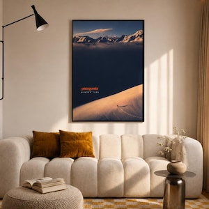 May include: A framed vertical wall art print featuring a snowy mountain landscape at sunset with the text Patagonia Winter 1995. The image displays a vast, dark blue sky above a bright, sunlit snow slope and distant, jagged, snow-capped peaks.